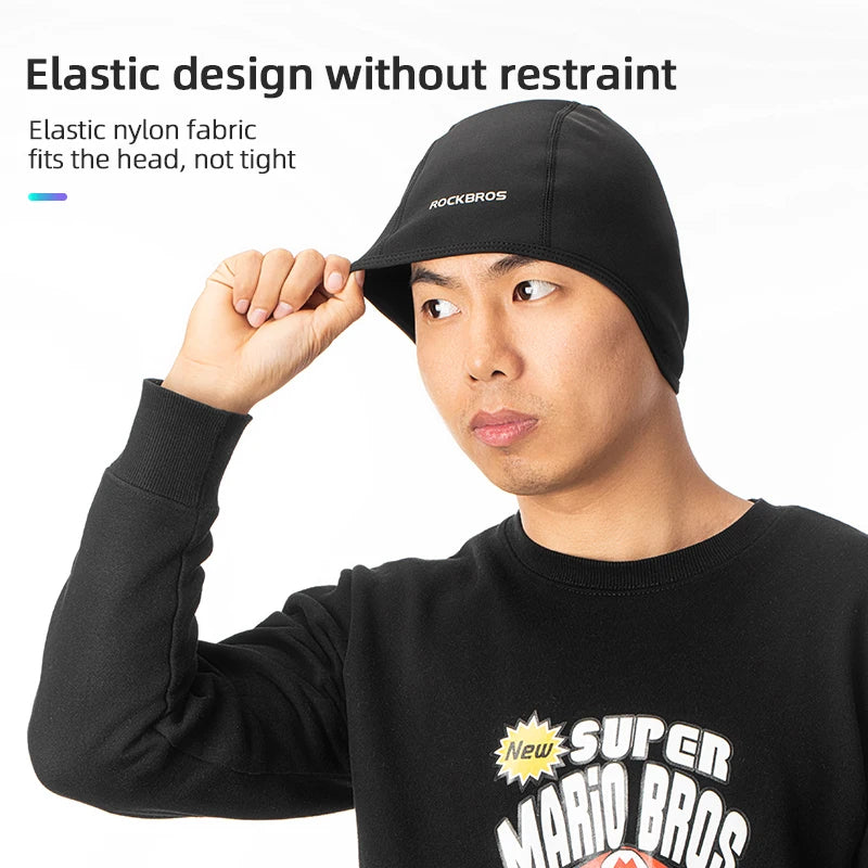 Black thermal cycling skull cap worn by model, snug elastic fit and logo